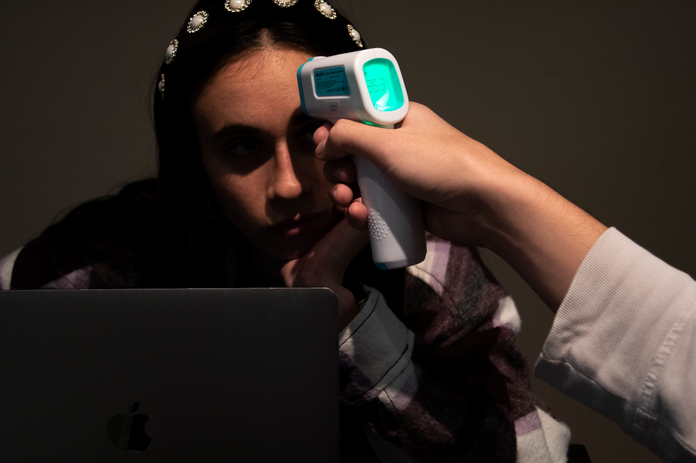 photo of person getting temperature taken with device